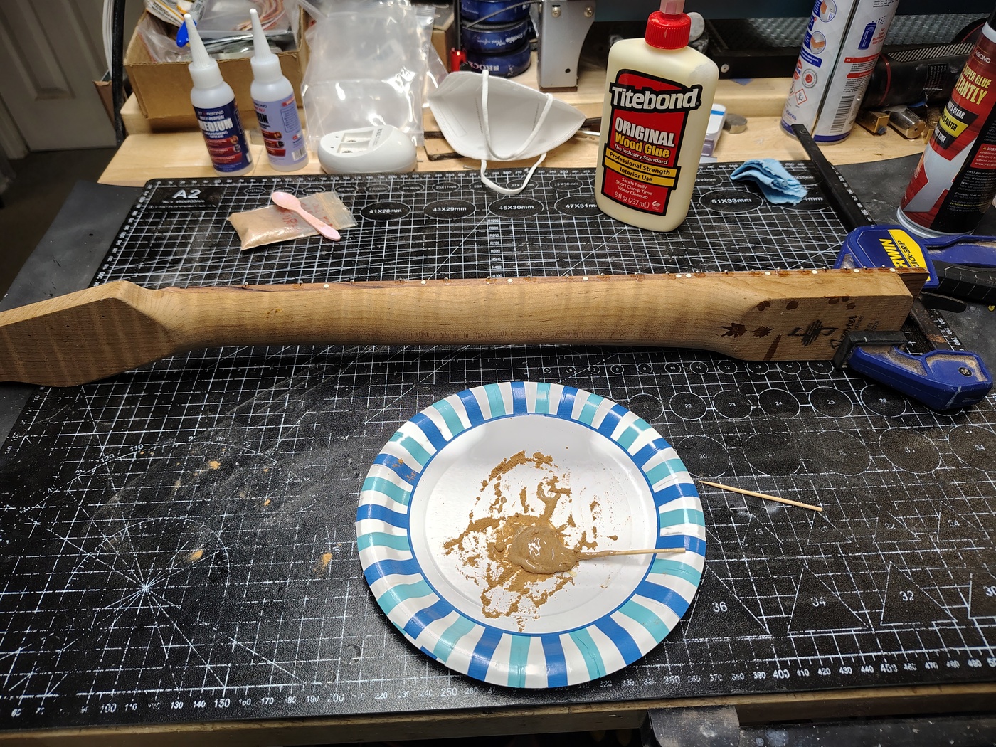 Filling the ends
                of the fret slots with glue and wood dust