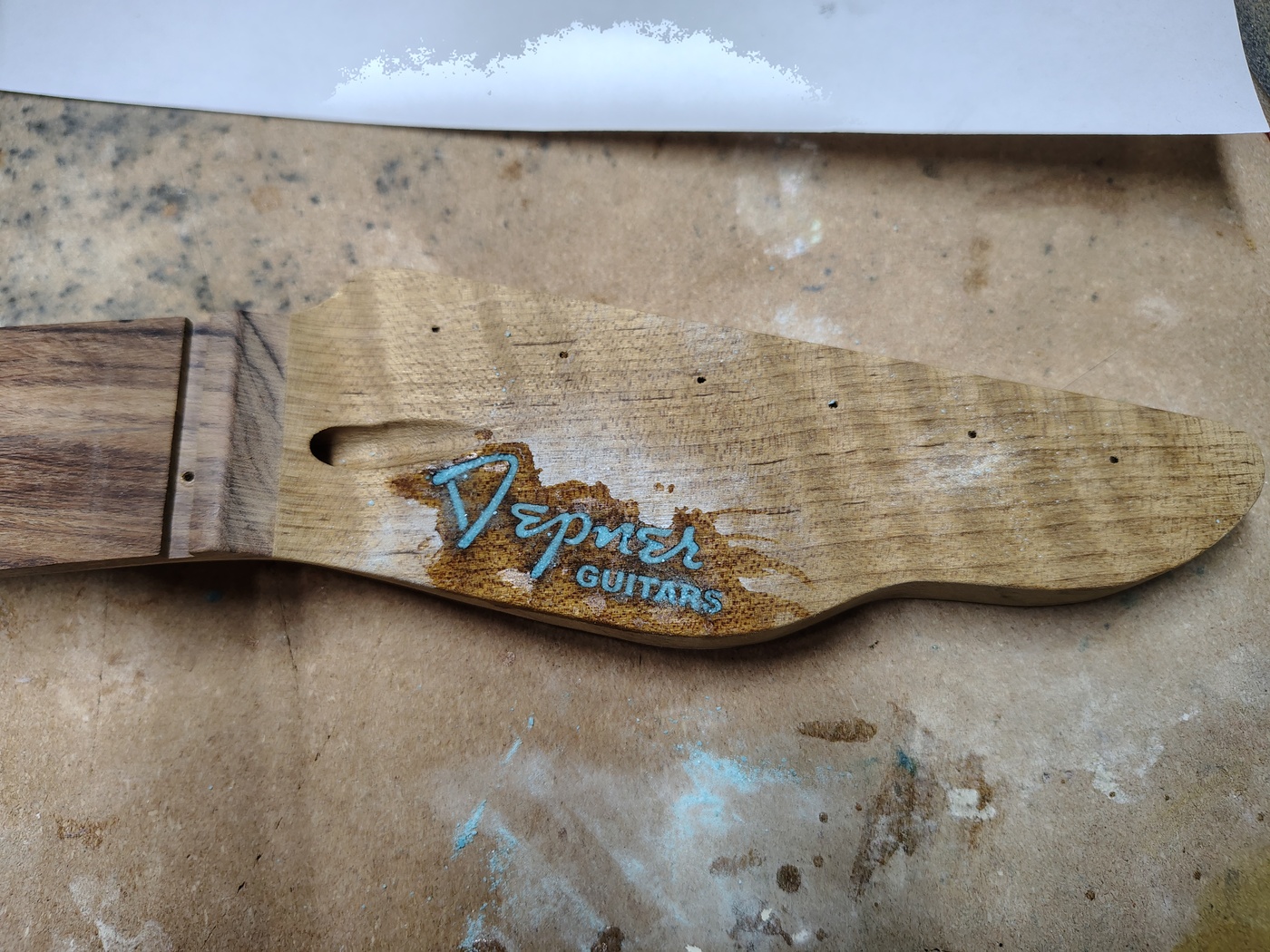 Peghead logo
                recess filled with crushed turquoise