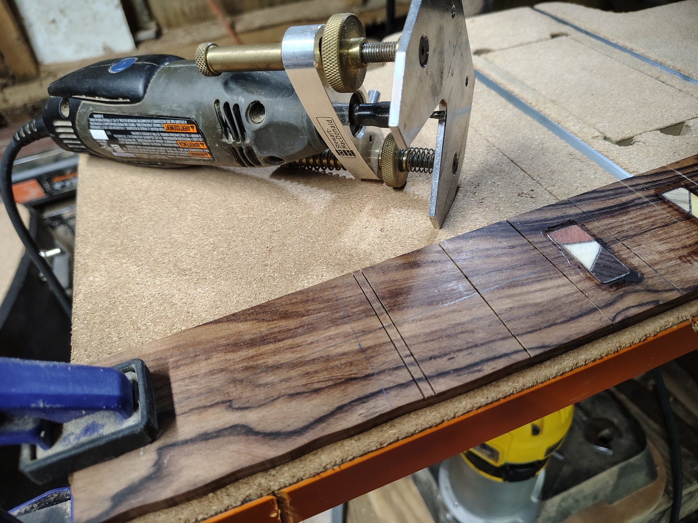 Preparing
                to rout the nut slot with a Dremel router